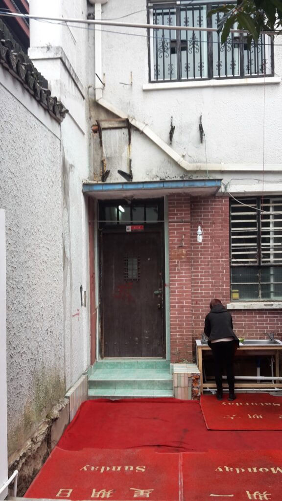 A grubby but interesting combination of wall/doors/windows/hand basin in Shanghai, China