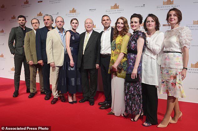 The cast and producers of Downton Abbey on the red carpet at the launch of an exhibition about the television series at the Marina Bay Sands on Wednesday, June 21, 2017, in Singapore. (AP Photo/Joseph Nair)