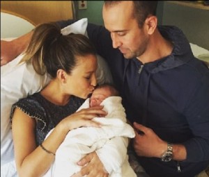 Rachel and husband Jason with newborn Harvy. Source