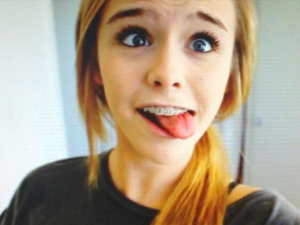 Girl braces tongue out