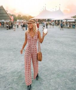 girl at festival wearing a pink 60's or 70's inspired outfit