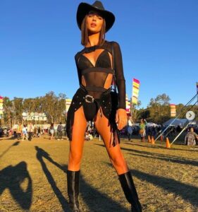 girl at festival wearing black cowgirl outfit