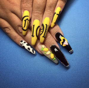 yellow black and white nail art on blue background