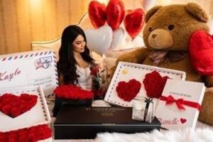 woman surrounded by Valentine's Day gifts from my lasting bouquet