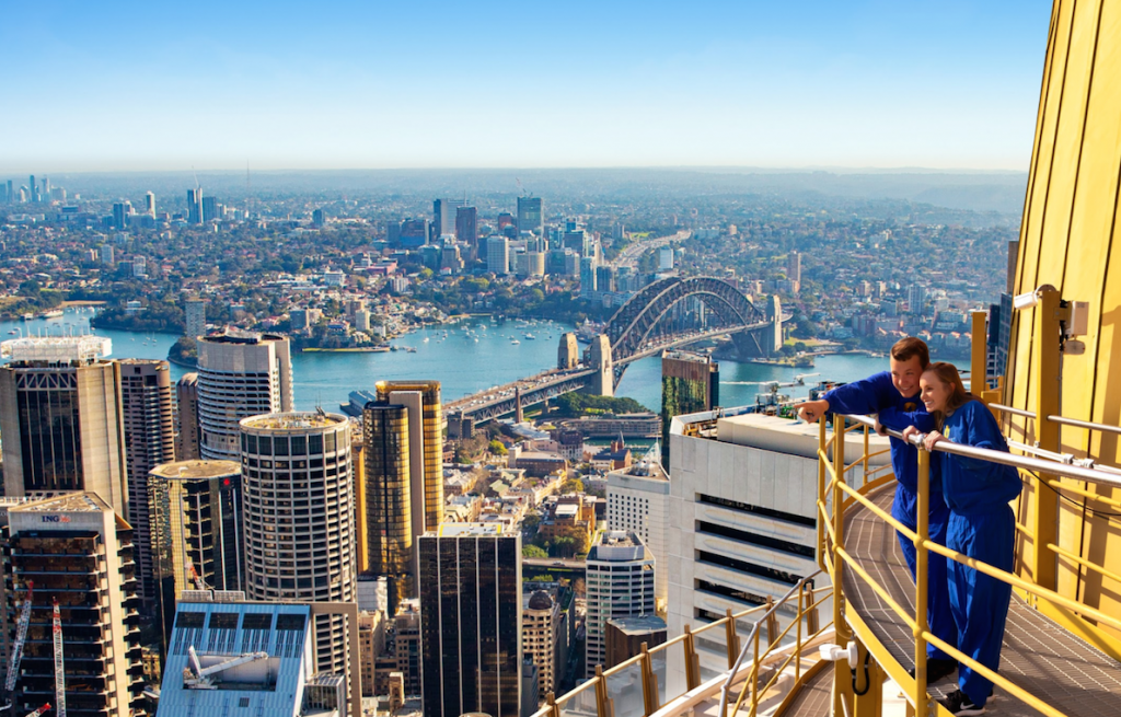 A couple looking at views of the city from the Sydney Tower Eye SKYWALK