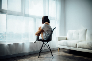 woman sitting on chair isolated lockdown sanity
