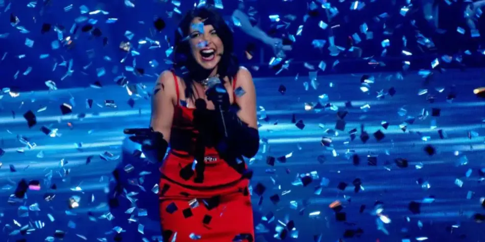 Natalie Gauci, winner of Australian Idol 2007, beams with joy while clutching a microphone amid a shower of celebratory confetti on stage