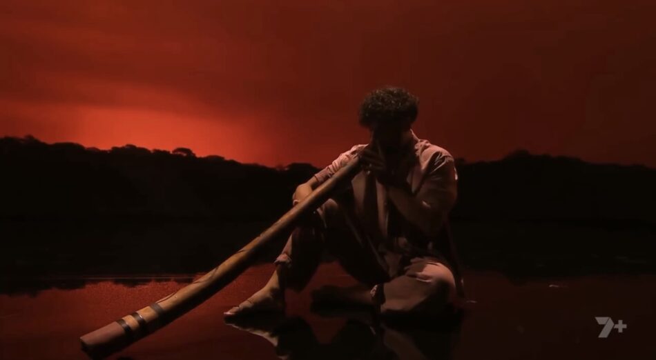 Kyle Shilling playing the didgeridoo at the start of the performance.