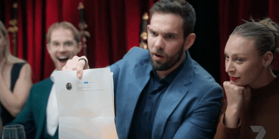 Michael holding a print out showing Amy is a private cook Instagram on My Kitchen Rules (MKR) with Rielli