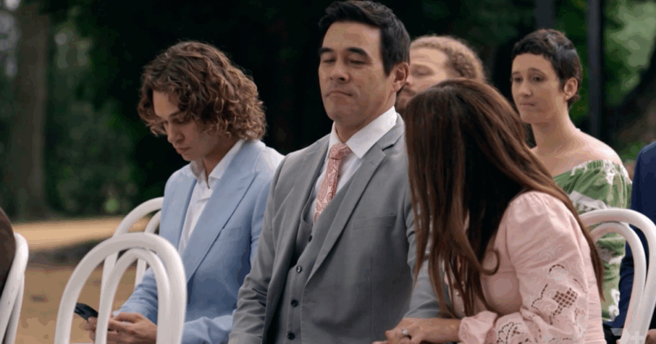 Theo on his phone at Cash and Eden's wedding