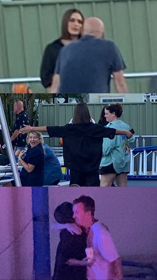 Holly hugging members of Big Brother Australia production.